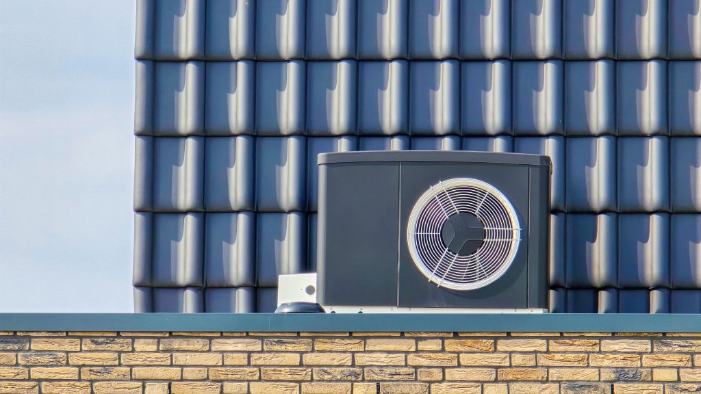 air source heat pump unit installed outdoors at a modern home with bricks in the Netherlands