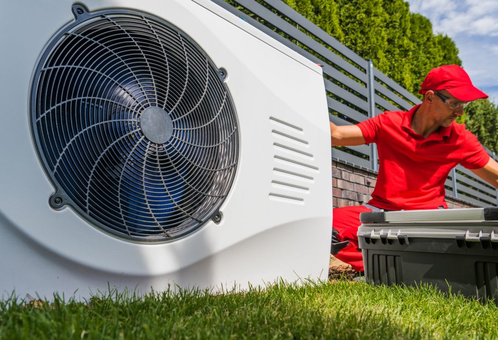 Professional HVAC Worker Installing Swimming Pool Heat Pump