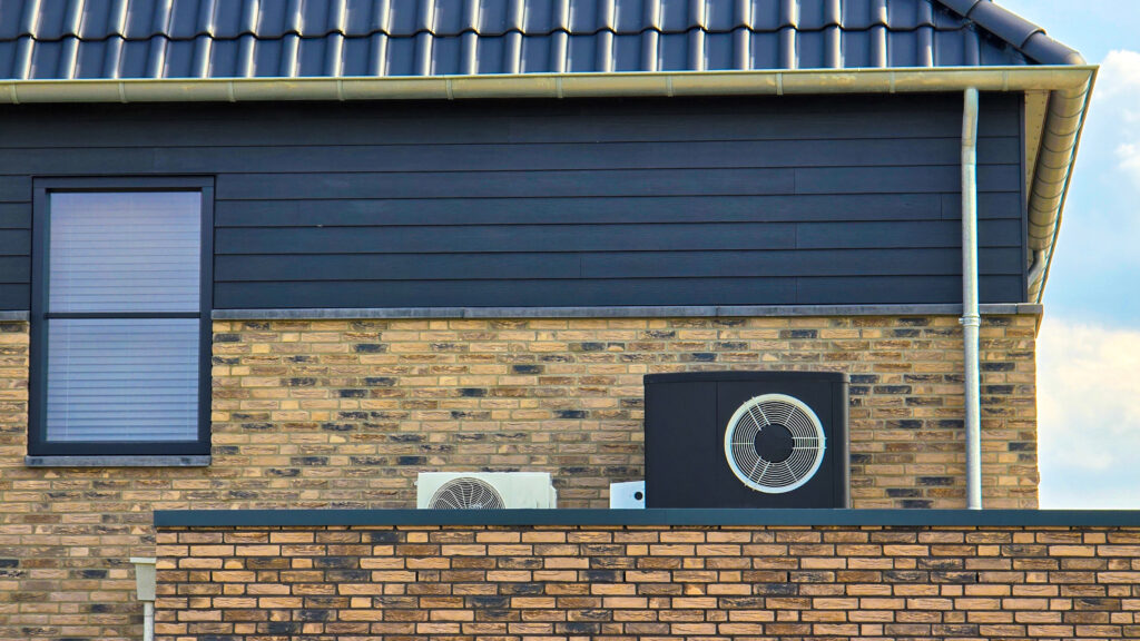 air source heat pump unit installed outdoors at a modern home with bricks in the Netherlands