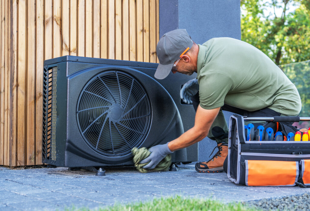 Technician Performs Maintenance on Outdoor Air Conditioning Unit